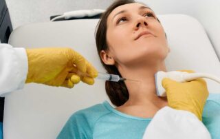 Medical professional in Lancaster performing a neck injection with ultrasound guidance, specializing as an FNA biopsy doctor Lancaster for precise fine needle aspiration procedures. | Cancer Biopsy & FNA Doctor in Los Angeles - Dr. Celina Nadelman
